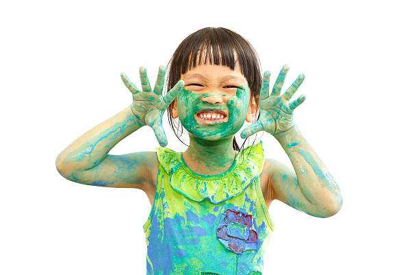 little girl with green paint on your hands